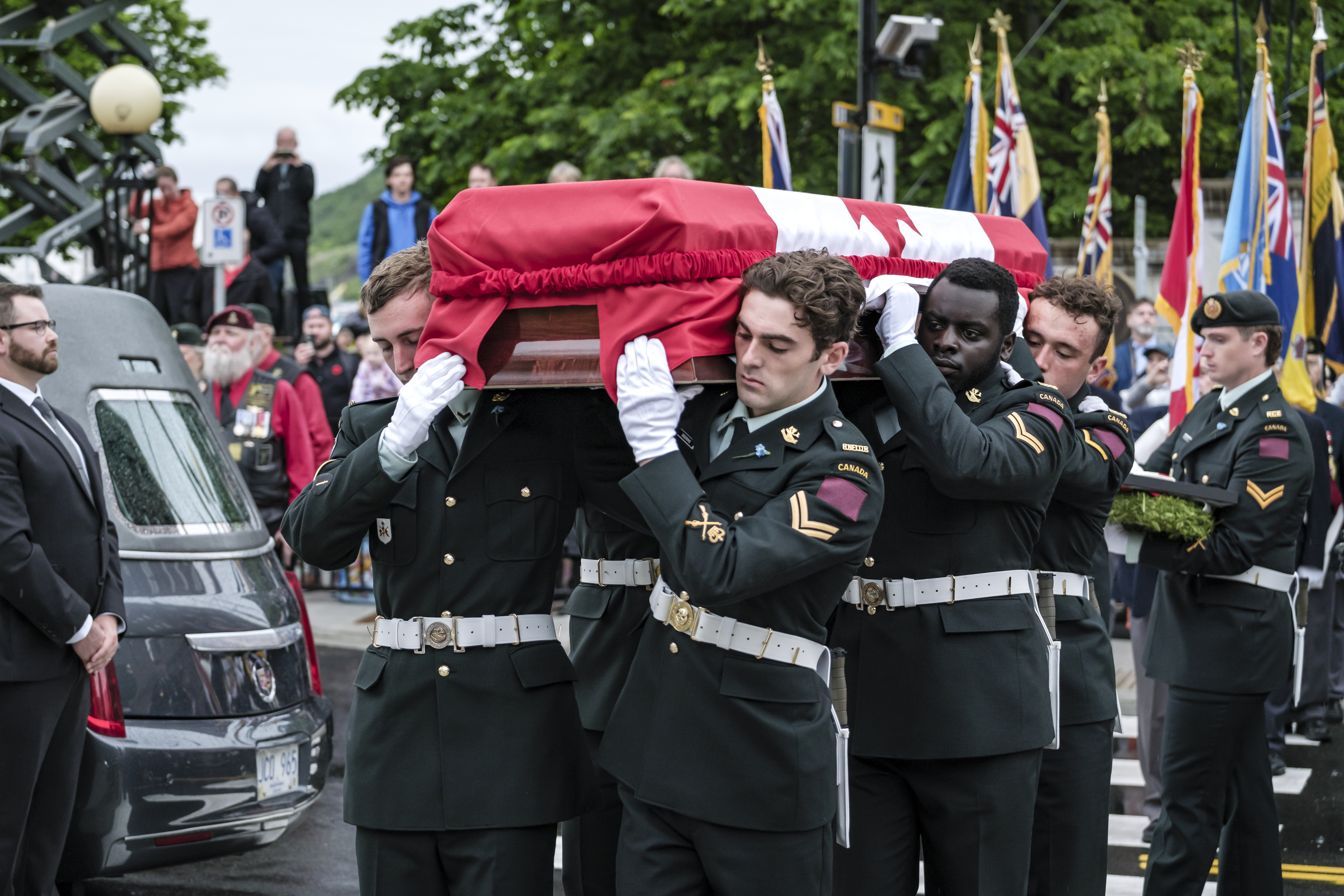 Six military personnel carrying the casket of the Newfoundland soldier whose remains were transported back to Canada for a final burial ceremony.