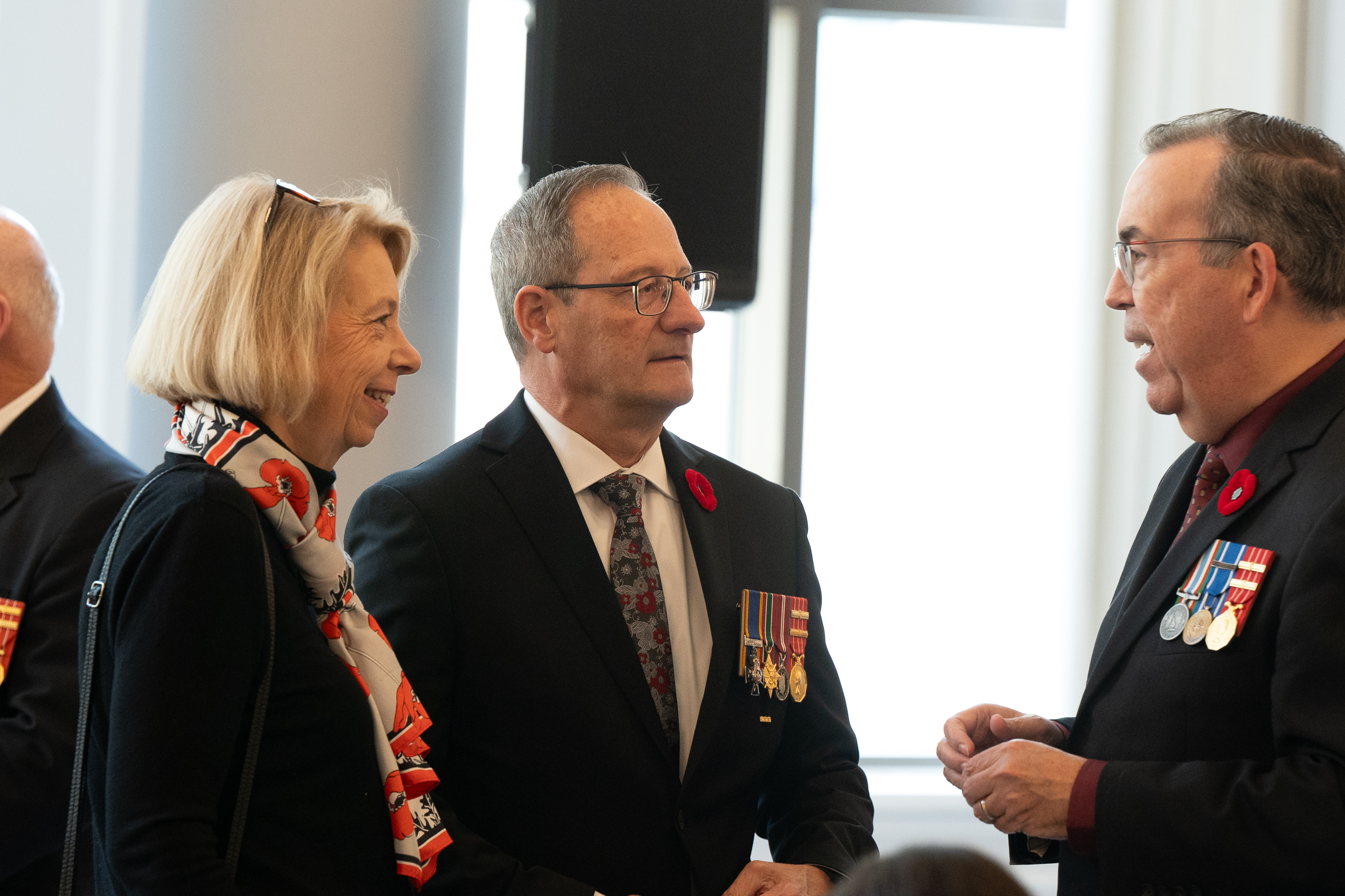 Board Deputy Chairperson Jacques Bouchard speaking with Board Member Patrice Carrière and a woman.